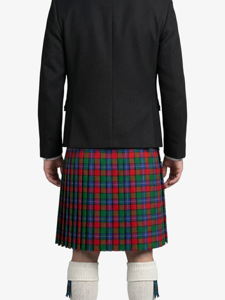 Person wearing a black jacket and a red, green, and blue plaid kilt on a white background