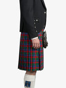 Person wearing a black jacket and red plaid kilt on a white background