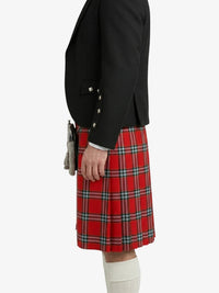 Person wearing a black jacket and red plaid kilt on a white background