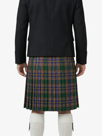 Person wearing a black jacket and plaid kilt on a white background