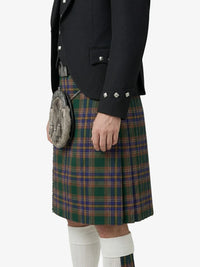 Person wearing a traditional Scottish kilt with a jacket and sporran on a white background