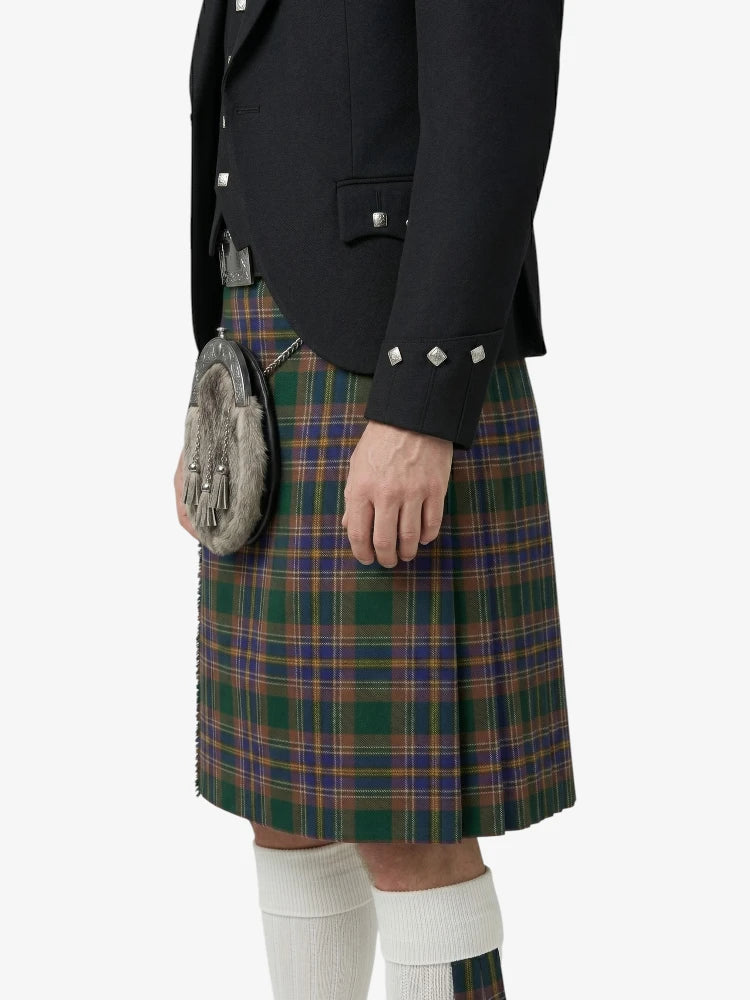 Person wearing a traditional Scottish kilt with a jacket and sporran on a white background