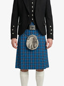 Person wearing a blue plaid kilt with a black jacket on a white background
