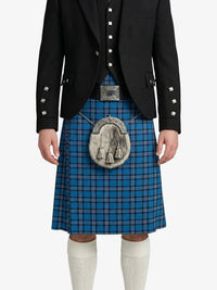 Person wearing a blue plaid kilt with a black jacket on a white background