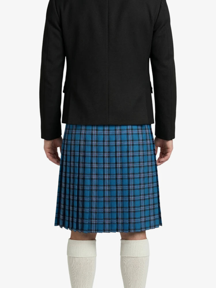 Person wearing a black jacket and blue plaid kilt on a white background