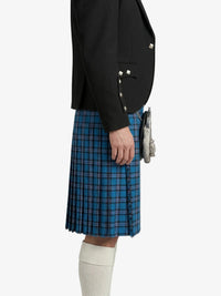 Person wearing a black jacket and blue plaid kilt on a white background