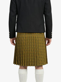 Person wearing a black jacket and plaid kilt on a white background