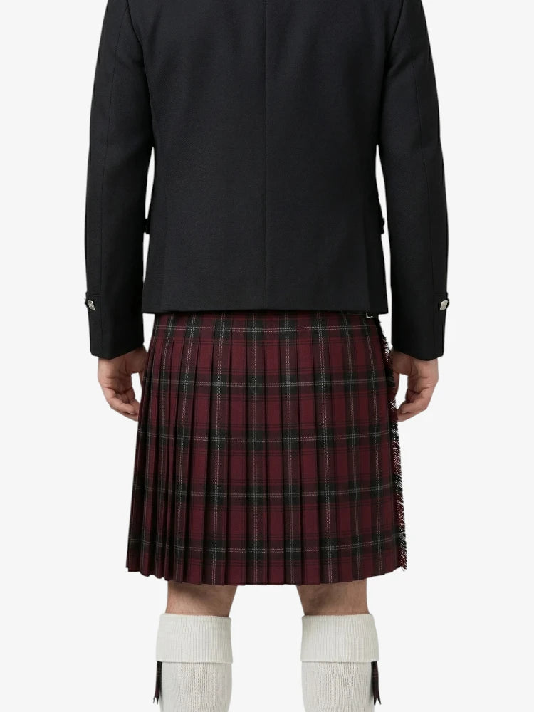 Person wearing a black jacket and red plaid kilt on a white background