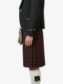 Person wearing a black jacket and red tartan kilt on a white background