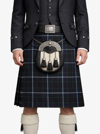 Person wearing a traditional Scottish kilt with a sporran on a white background