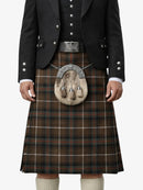 Traditional Scottish kilt with a tartan pattern worn by a person on a white background