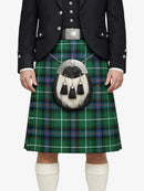 Person wearing a traditional Scottish kilt with a tartan pattern on a white background