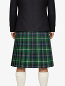 Person wearing a black jacket and green plaid kilt on a white background