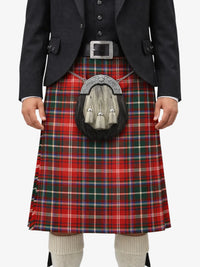 Person wearing a red tartan kilt with a black jacket and white shirt on a white background