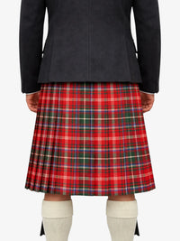 Person wearing a black jacket and red plaid kilt on a white background