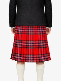 Person wearing a red plaid kilt with a black top on a white background