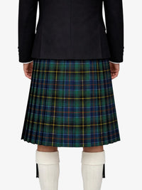 Person wearing a black jacket and green plaid kilt on a white background