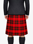Person wearing a red plaid kilt with a black jacket on a white background