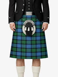 Person wearing a traditional Scottish kilt with a visible tartan pattern on a white background
