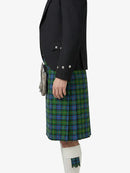 Person wearing a black jacket and green plaid kilt on a white background