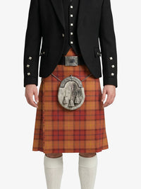 Person wearing a traditional Scottish kilt with a black jacket on a white background