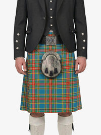 Person wearing a traditional Scottish kilt with a tartan pattern on a white background