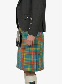 Person wearing a gray jacket and a colorful plaid kilt on a white background