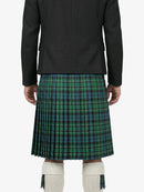 Person wearing a green plaid kilt on a white background