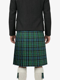 Person wearing a green plaid kilt on a white background