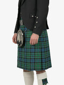 Person wearing a green plaid kilt with a black jacket on a white background