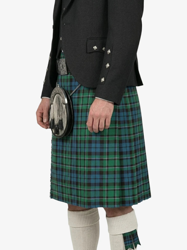Person wearing a green plaid kilt with a black jacket on a white background