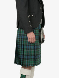 Person wearing a black jacket and green plaid kilt on a white background