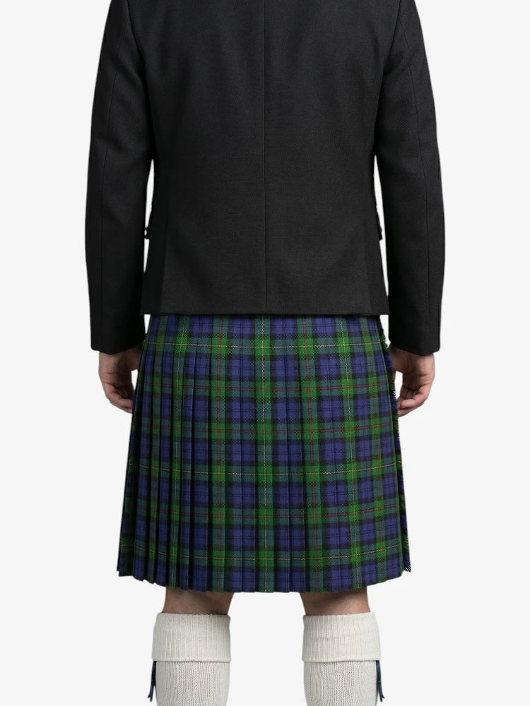 Person wearing a black jacket and a green and blue plaid kilt on a white background