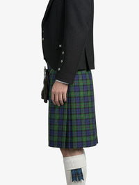 Person wearing a black jacket and green plaid kilt on a white background
