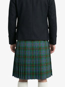 Person wearing a black jacket and green plaid kilt on a white background
