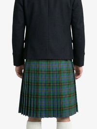 Person wearing a black jacket and green plaid kilt on a white background