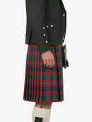 Person wearing a black jacket and red plaid kilt on a white background