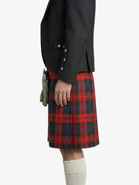 Person wearing a black jacket and red plaid kilt on a white background