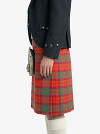 Person wearing a dark jacket and red plaid kilt on a white background