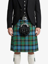 Person wearing a black jacket and a green plaid kilt on a white background