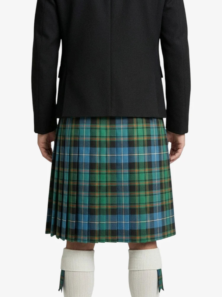 Person wearing a black jacket and plaid kilt on a white background