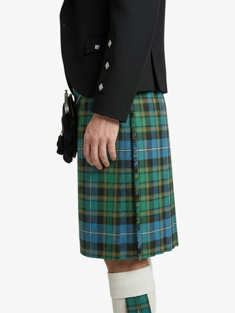 Person wearing a green plaid kilt with a black jacket on a white background