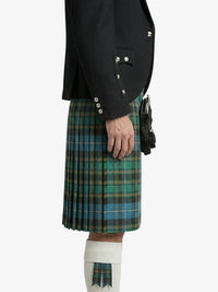 Person wearing a black jacket and green plaid kilt on a white background