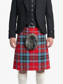 Person wearing a red plaid kilt with a black jacket on a white background