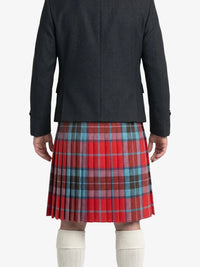Person wearing a red plaid kilt with a plain background
