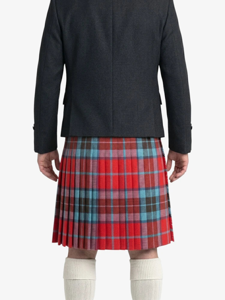 Person wearing a red plaid kilt with a plain background