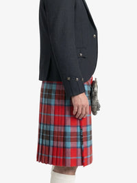 Person wearing a dark jacket and red plaid kilt on a white background
