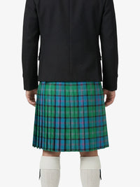 Person wearing a black jacket and green plaid kilt on a white background