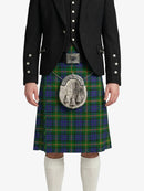 Person wearing a black jacket and blue plaid kilt with a silver emblem on a white background