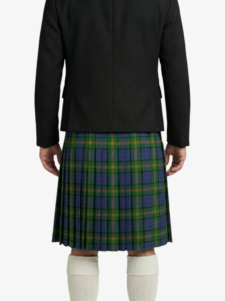 Person wearing a black jacket and green plaid kilt on a white background